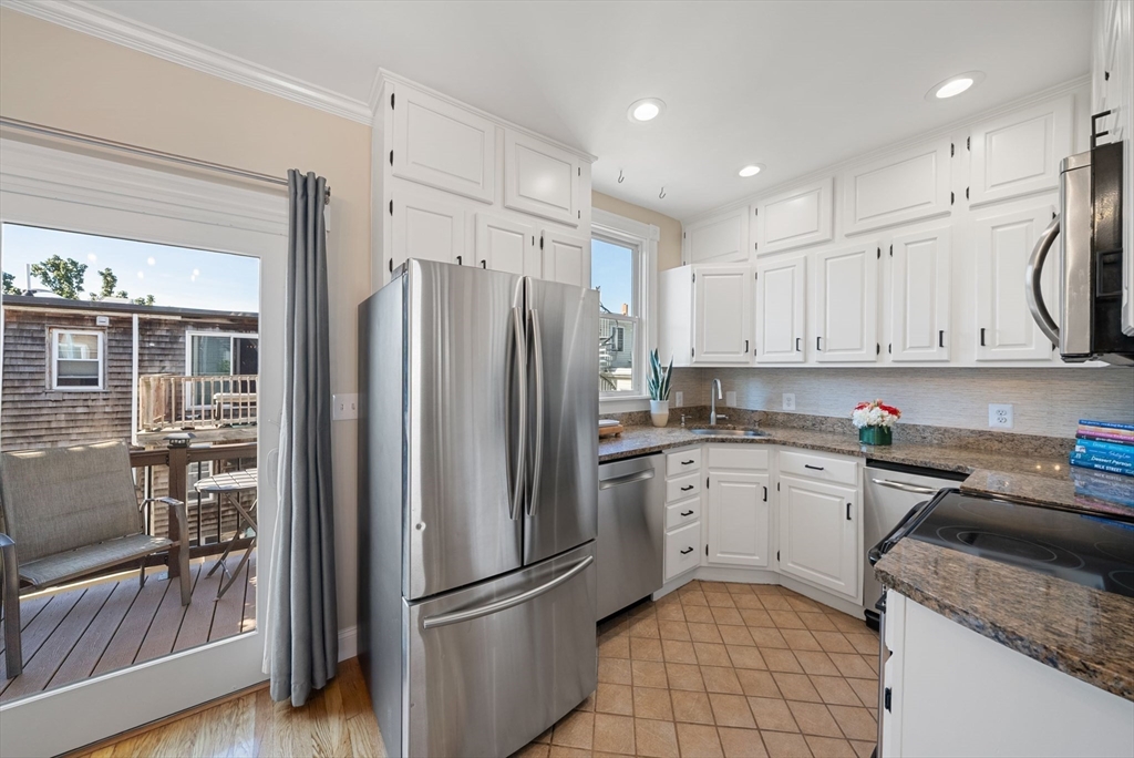 11 Wall Street Boston, MA 02129 - Photo 8 of 33 a kitchen with a refrigerator a sink and a stove top oven
