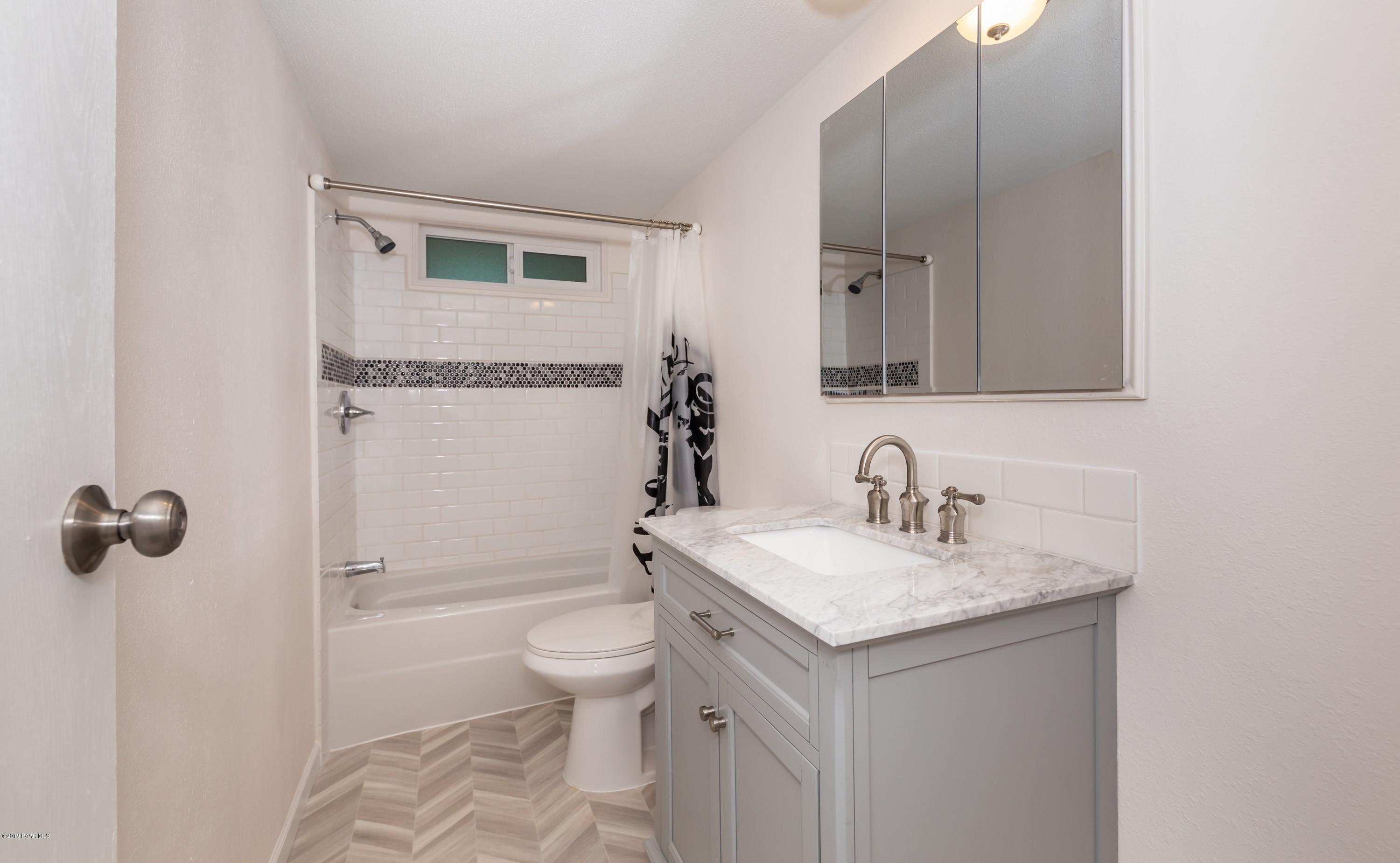 25156 North Stump Road Paulden, AZ 86334 - Photo 12 of 17 a bathroom with a granite countertop sink a toilet and shower
