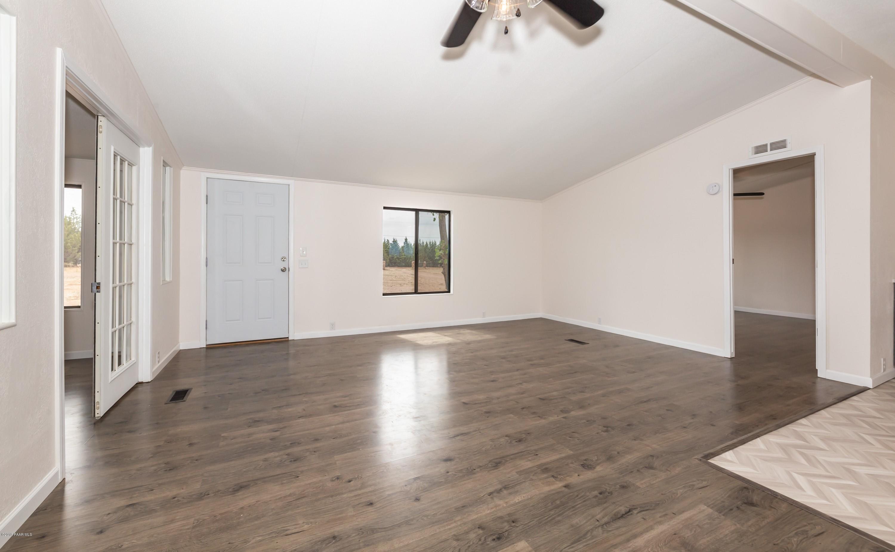 25156 North Stump Road Paulden, AZ 86334 - Photo 4 of 17 an empty room with wooden floor cabinet and windows