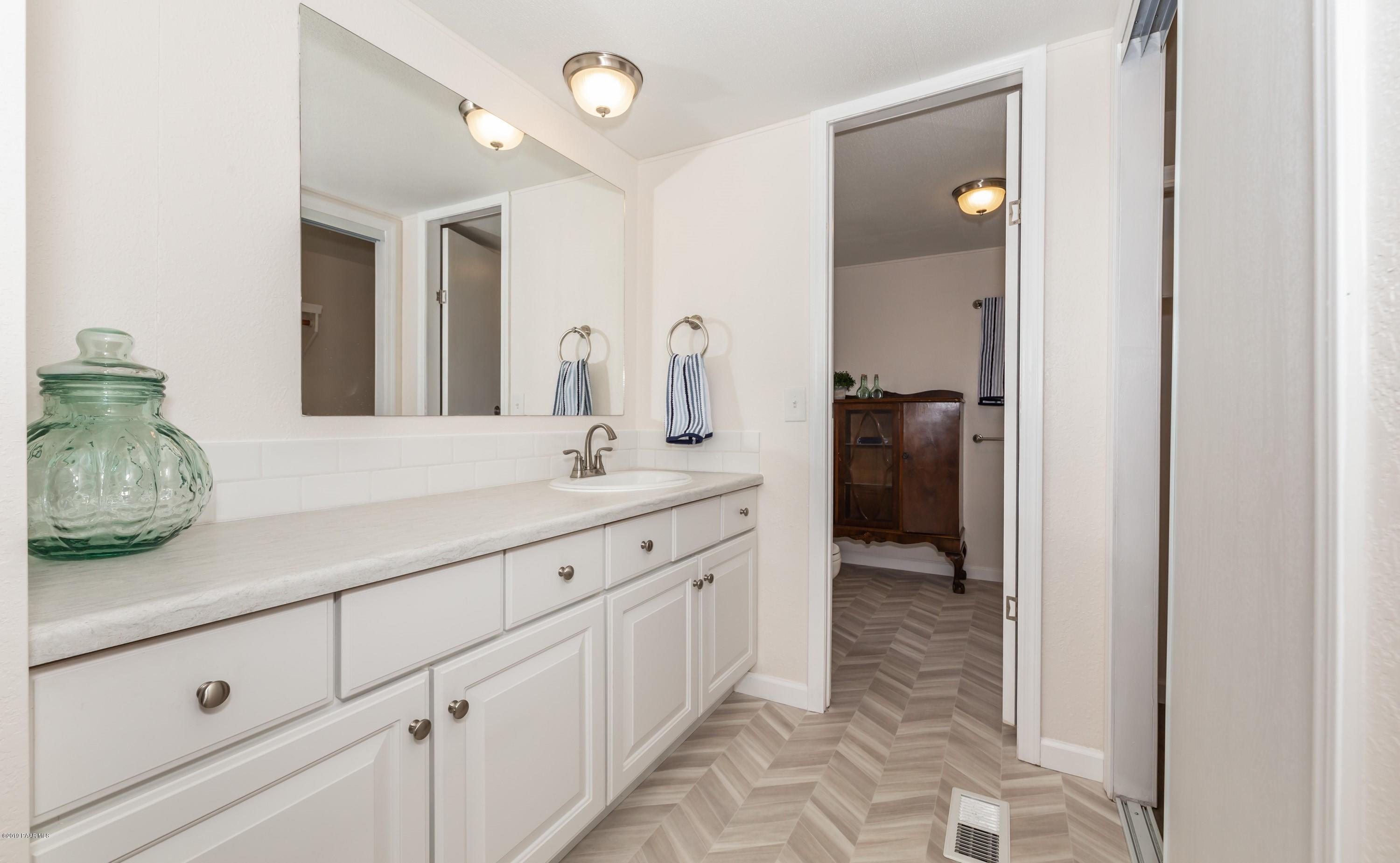 25156 North Stump Road Paulden, AZ 86334 - Photo 9 of 17 a spacious bathroom with a granite countertop sink and a mirror