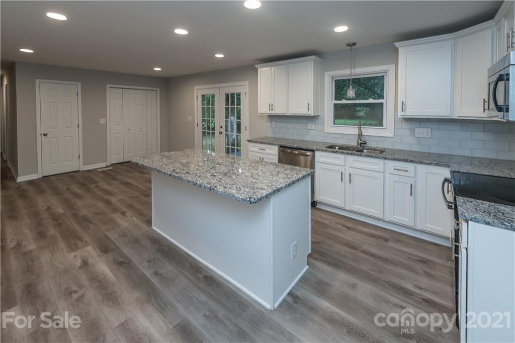 1060 Dunlap Roddey Road Rock Hill, SC 29730 - Photo 12 of 30 a kitchen with stainless steel appliances granite countertop a sink cabinets and wooden floor