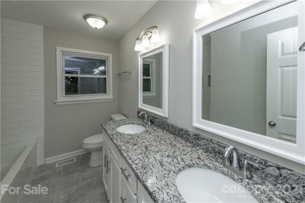 1060 Dunlap Roddey Road Rock Hill, SC 29730 - Photo 17 of 30 a bathroom with a granite countertop double vanity sink and a mirror