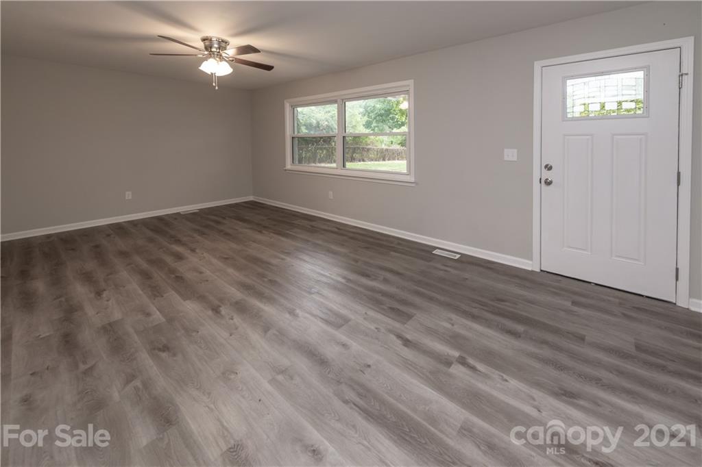 1060 Dunlap Roddey Road Rock Hill, SC 29730 - Photo 4 of 30 a view of empty room with wooden floor and fan