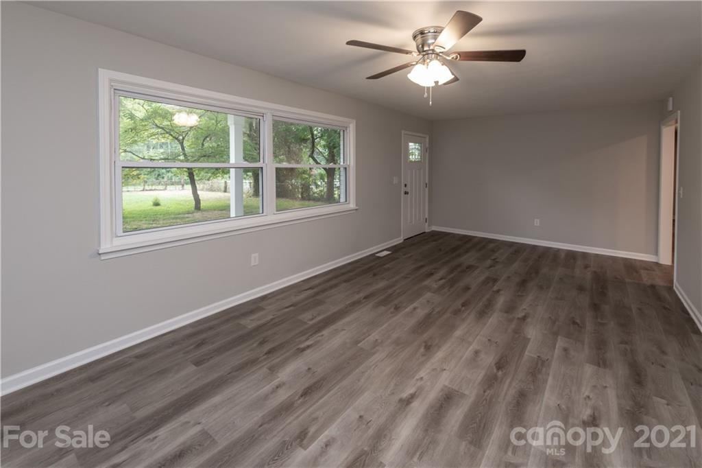 1060 Dunlap Roddey Road Rock Hill, SC 29730 - Photo 5 of 30 a view of an empty room with window and wooden floor