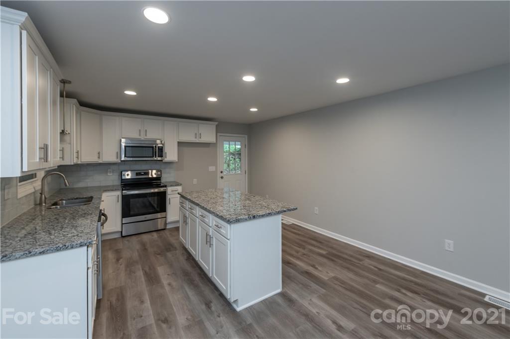 1060 Dunlap Roddey Road Rock Hill, SC 29730 - Photo 10 of 30 a kitchen with a sink window and stainless steel appliances
