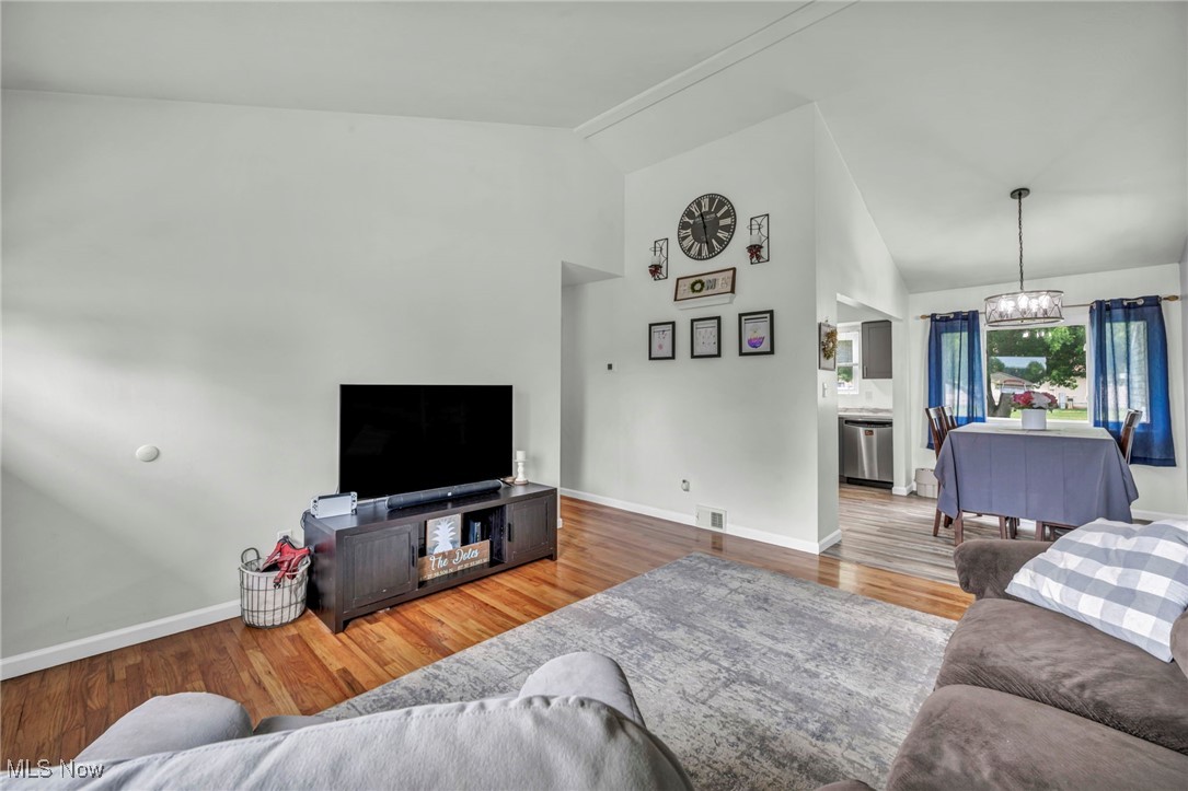 15025 Holland Road Brook Park, OH 44142 - Photo 6 of 12 Living area featuring a chandelier, wood finished floors, and high vaulted ceiling