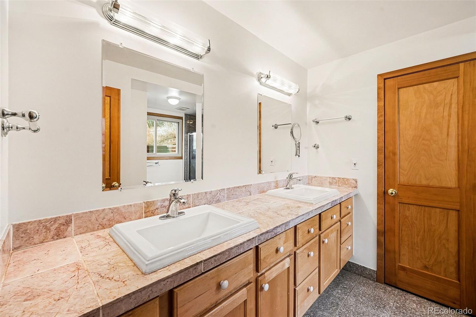 6094 Pyrenees Trail Golden, CO 80403 - Photo 11 of 24 a bathroom with a sink and a mirror
