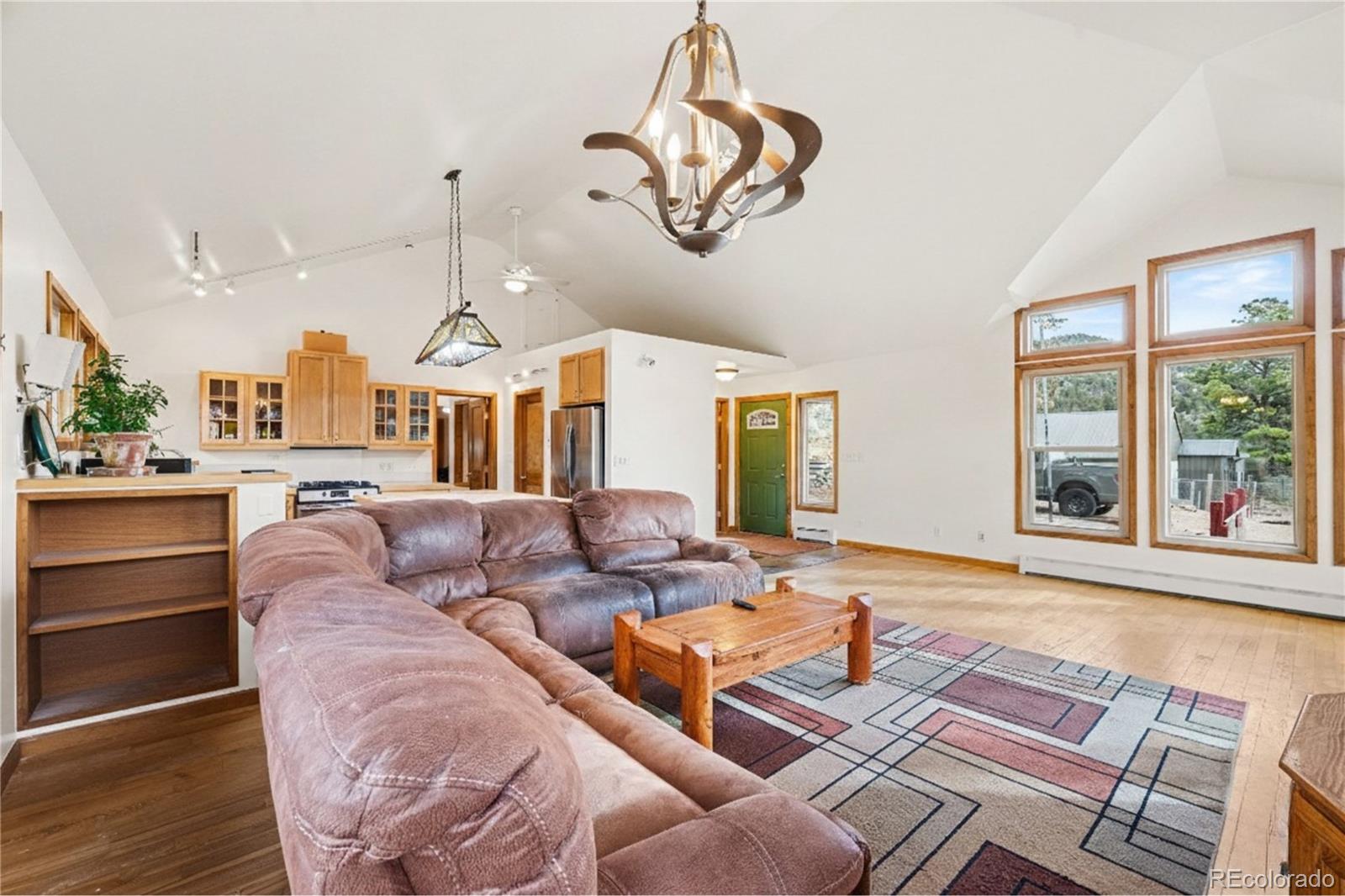 6094 Pyrenees Trail Golden, CO 80403 - Photo 2 of 24 a living room with furniture chandelier and a large window