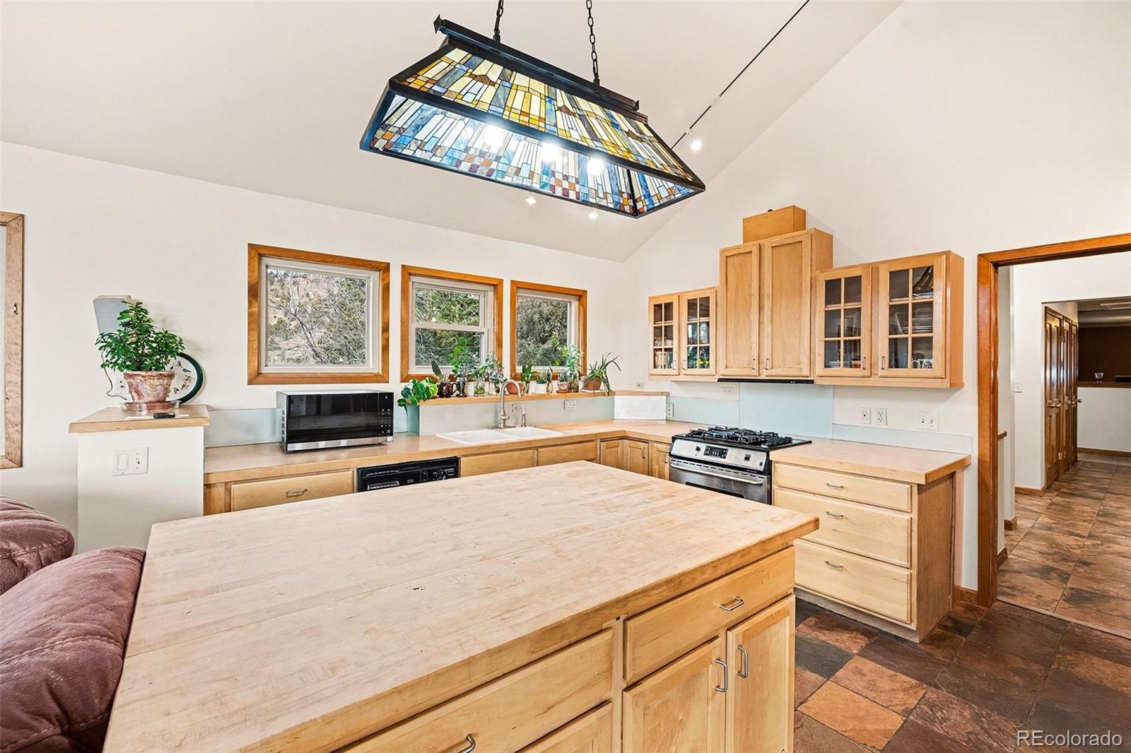 6094 Pyrenees Trail Golden, CO 80403 - Photo 4 of 24 a kitchen with a stove a sink and a refrigerator