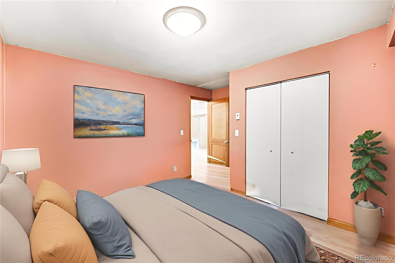 6094 Pyrenees Trail Golden, CO 80403 - Photo 9 of 24 a bedroom with a bed and a potted plant