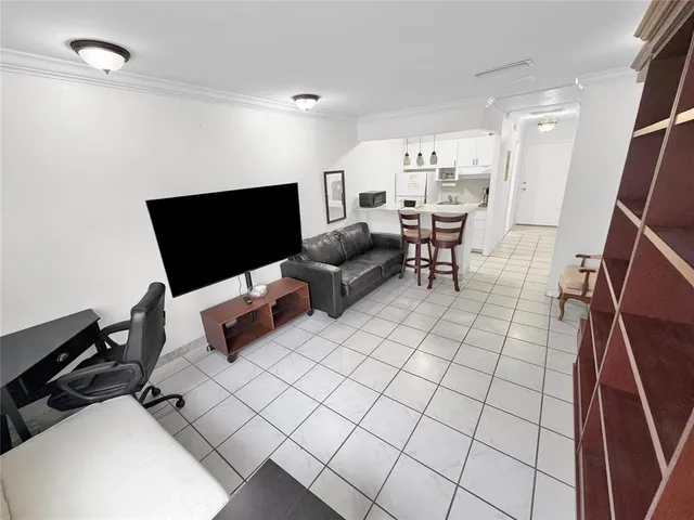a kitchen with a sink a stove and white cabinets