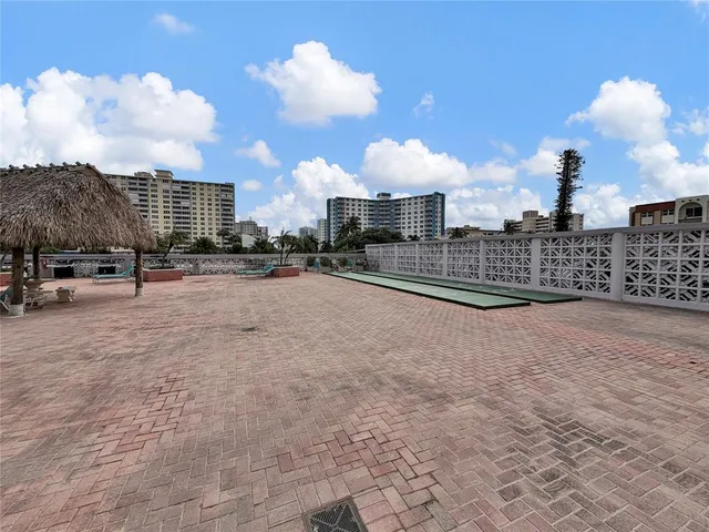a view of a terrace with lawn chairs and potted plants
