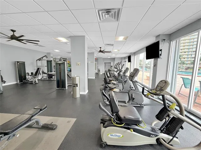 a room with gym equipment and windows