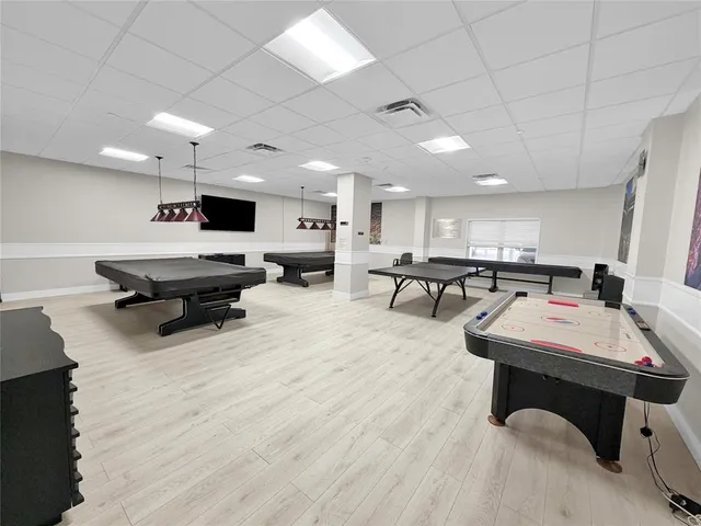 a living room with lots of furniture and view of kitchen