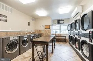 a view of a storage and utility room with furniture washer and dryer