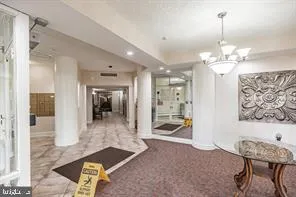 a lobby with furniture and a chandelier