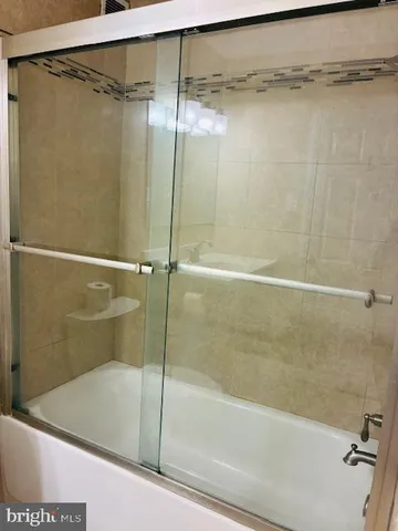 a bathroom with a shower and a bath tub