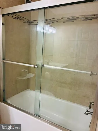 a bathroom with a shower and a bath tub