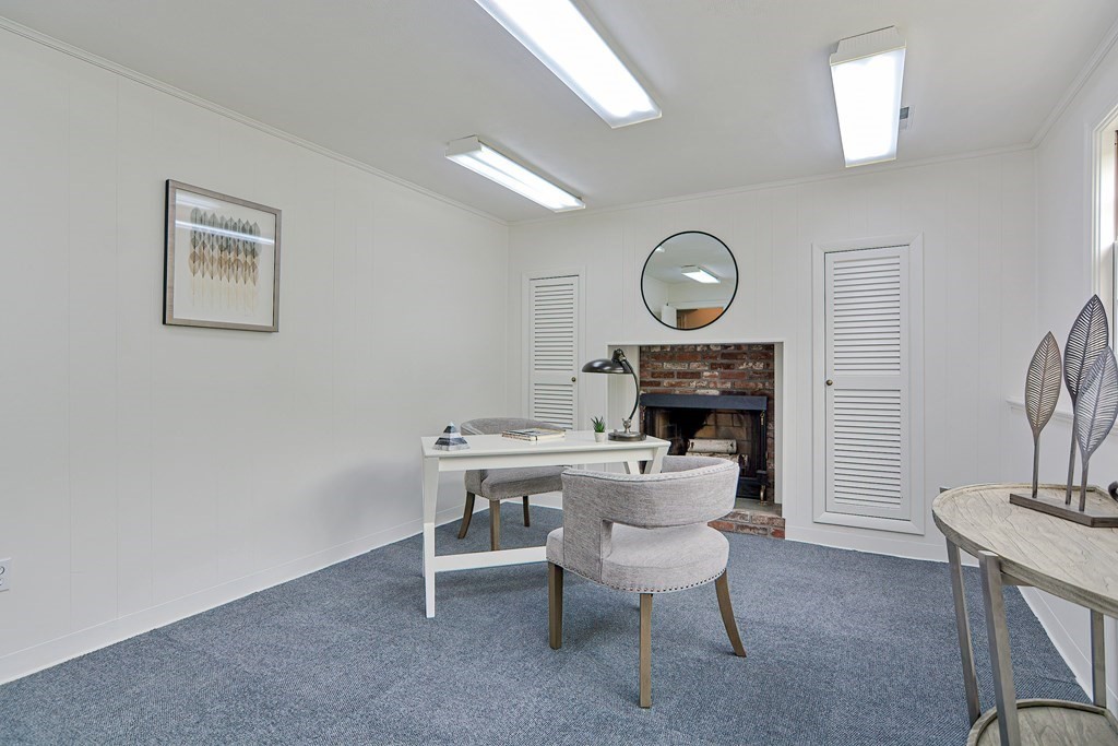105 Booth Road Dedham, MA 02026 - Photo 21 of 39 a living room with furniture a fireplace and a table