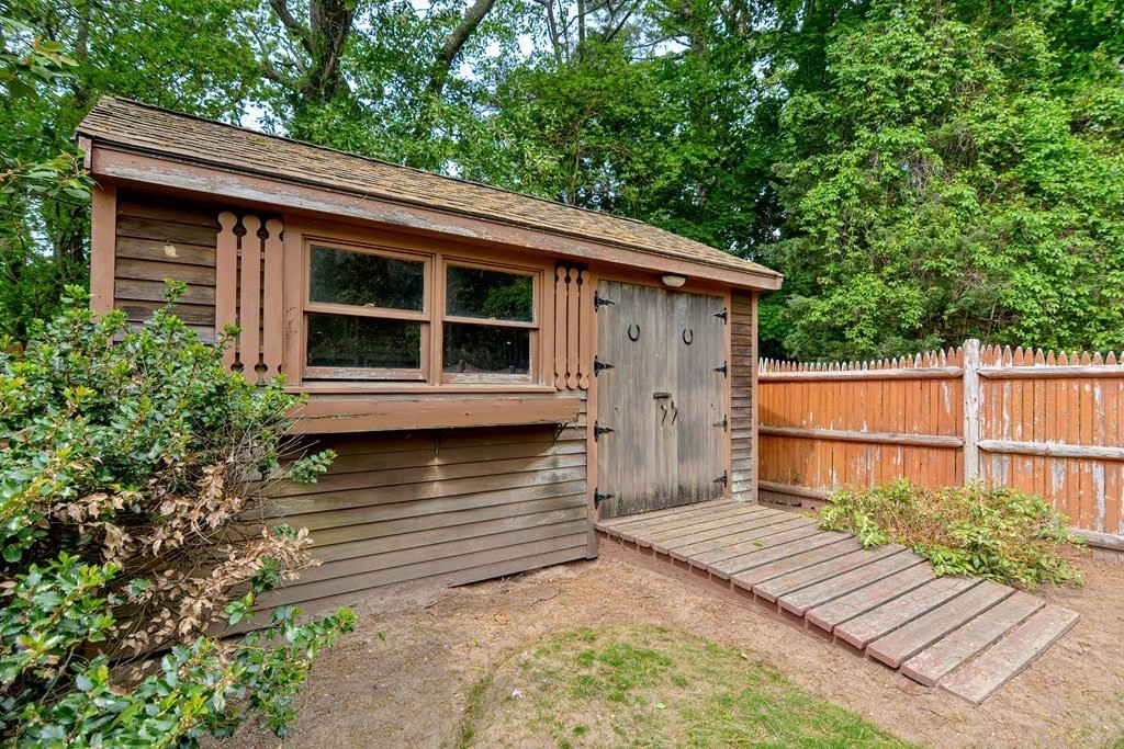105 Booth Road Dedham, MA 02026 - Photo 38 of 39 a view of a house with a wooden deck and a large tree