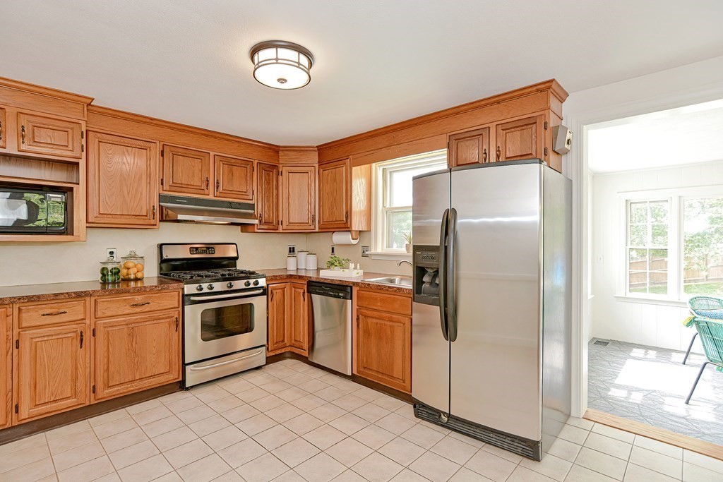 105 Booth Road Dedham, MA 02026 - Photo 7 of 39 a kitchen with stainless steel appliances granite countertop a refrigerator stove top oven and sink