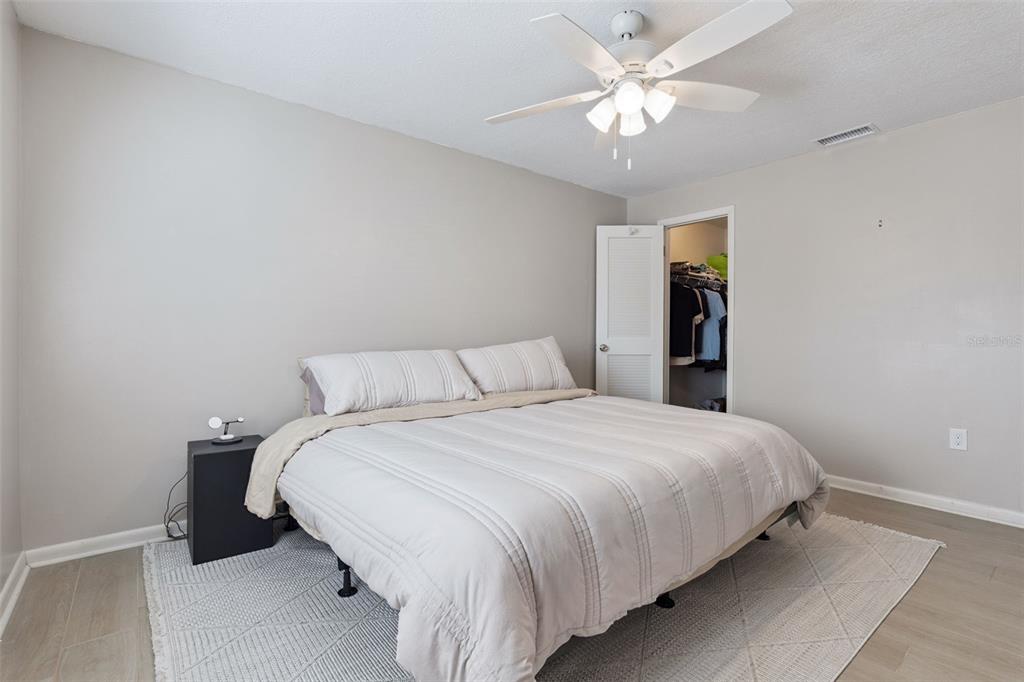 525 South Conway Road, Unit 202 Orlando, FL 32807 - Photo 14 of 34 a bedroom with a bed and a chandelier