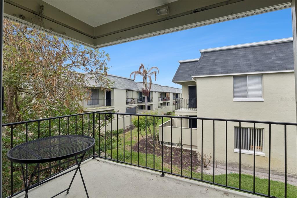 525 South Conway Road, Unit 202 Orlando, FL 32807 - Photo 20 of 34 a view of a white house with a small yard and furniture