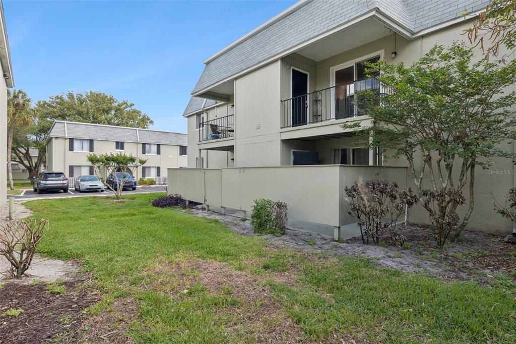 525 South Conway Road, Unit 202 Orlando, FL 32807 - Photo 23 of 34 a view of backyard of house with outdoor seating and green space