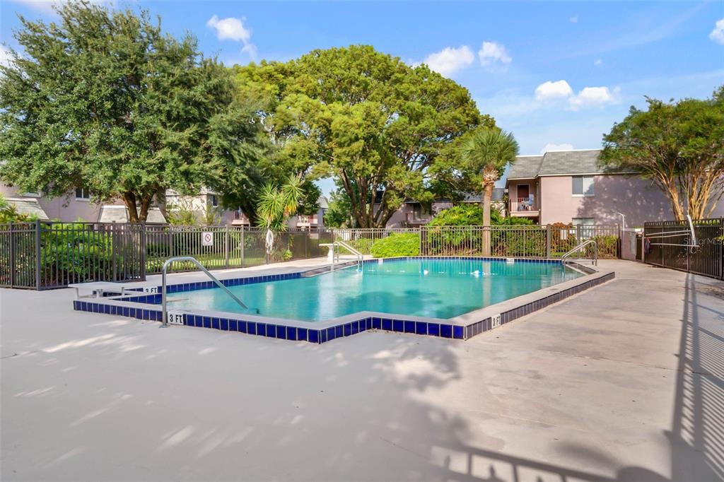 525 South Conway Road, Unit 202 Orlando, FL 32807 - Photo 27 of 34 a view of a swimming pool with a yard