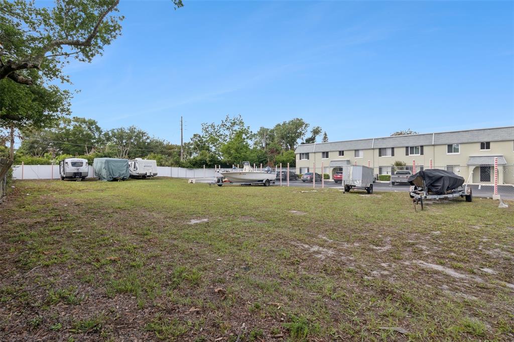 525 South Conway Road, Unit 202 Orlando, FL 32807 - Photo 32 of 34 a view of yard with swimming pool and trees