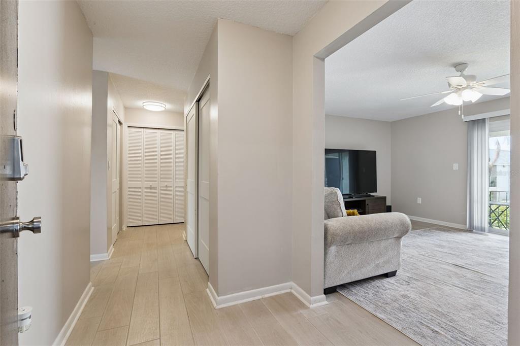 525 South Conway Road, Unit 202 Orlando, FL 32807 - Photo 4 of 34 a living room with furniture and a flat screen tv
