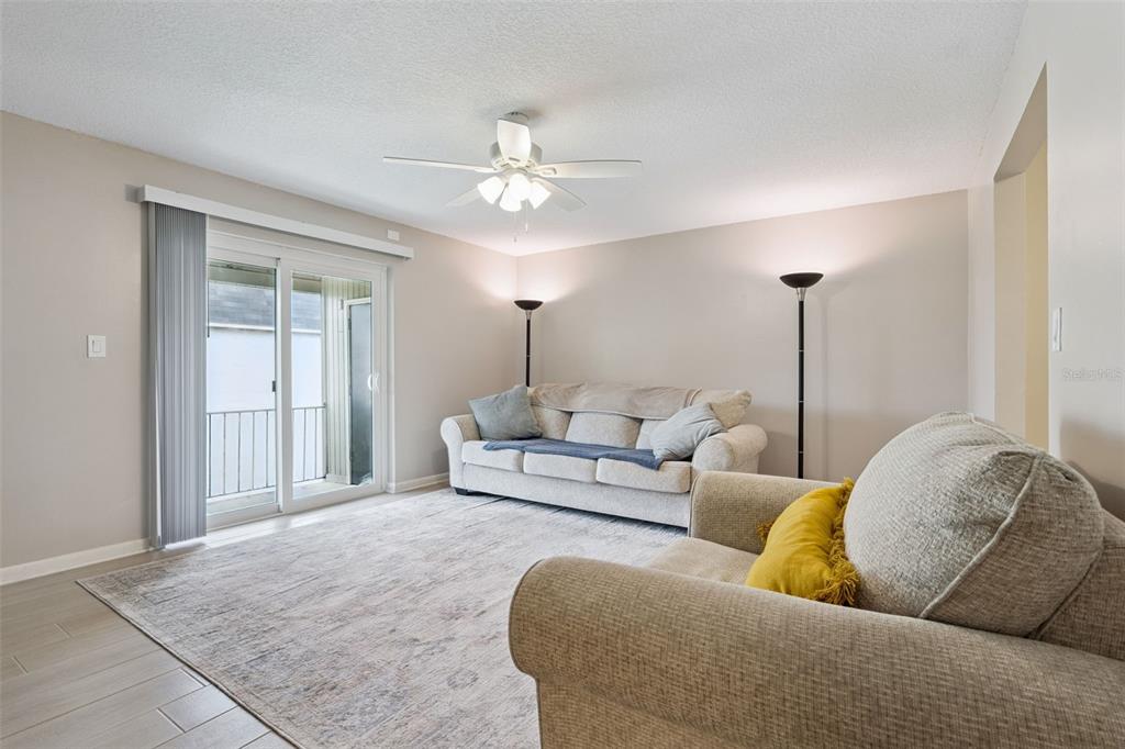 525 South Conway Road, Unit 202 Orlando, FL 32807 - Photo 6 of 34 a living room with furniture and a chandelier