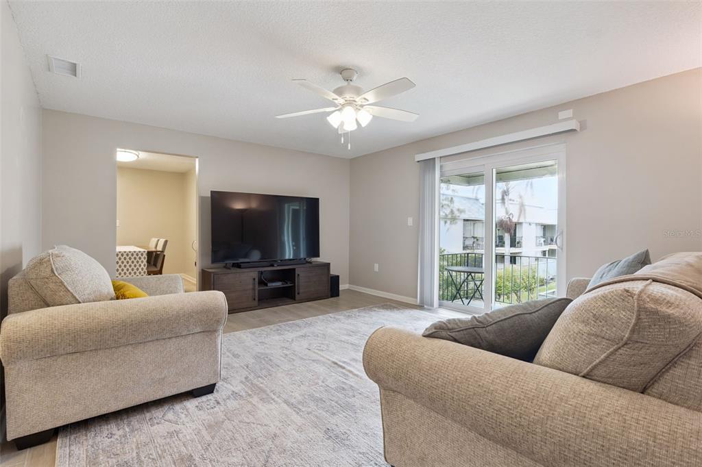 525 South Conway Road, Unit 202 Orlando, FL 32807 - Photo 7 of 34 a living room with furniture and a flat screen tv