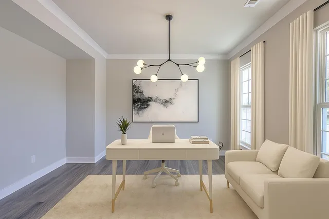 a view of an empty room with wooden floor and a chandelier fan