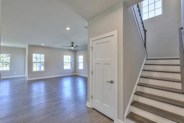 a large kitchen with hardwood floor and a large window