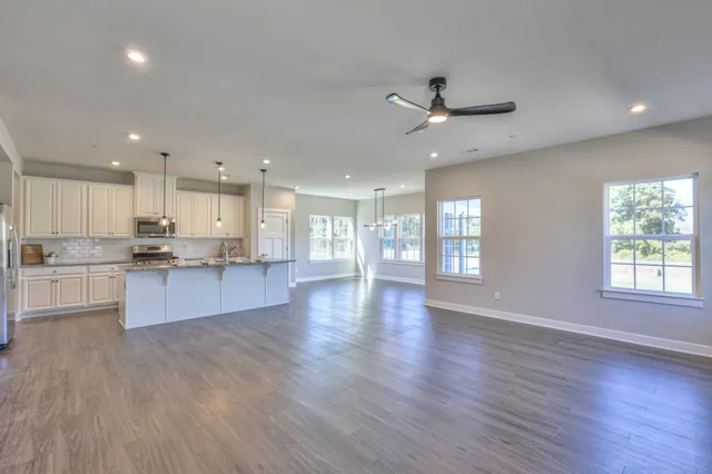 a kitchen with stainless steel appliances granite countertop a sink a stove and a refrigerator