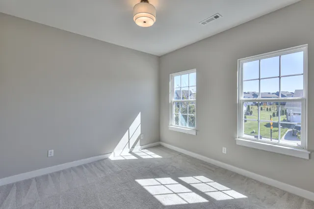 a view of an empty room and closet area