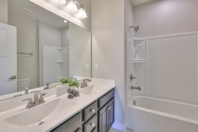 an empty room with closet and a chandelier fan