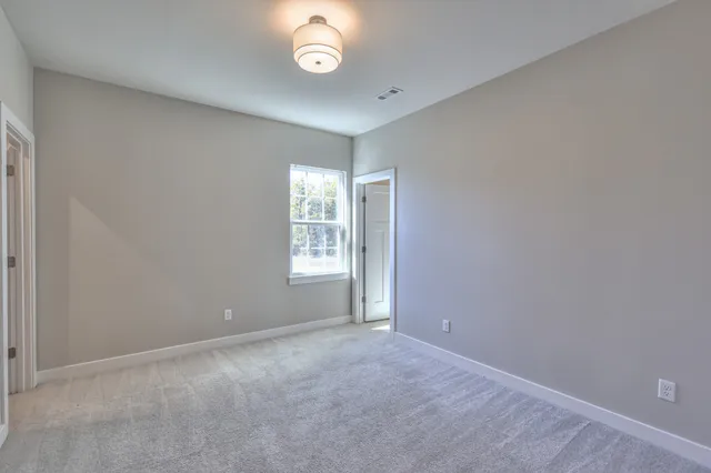 a view of a hallway with windows and entryway