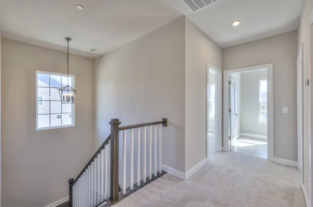 a view of a chandelier in big room and a bathroom