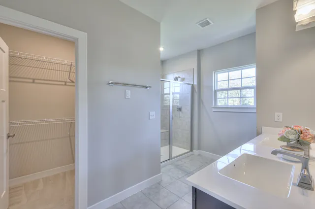 a front view of a house with a garden and yard