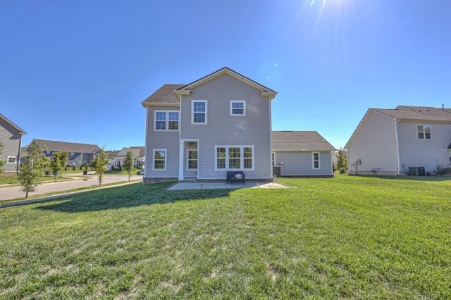 a view of a field with trees in the background