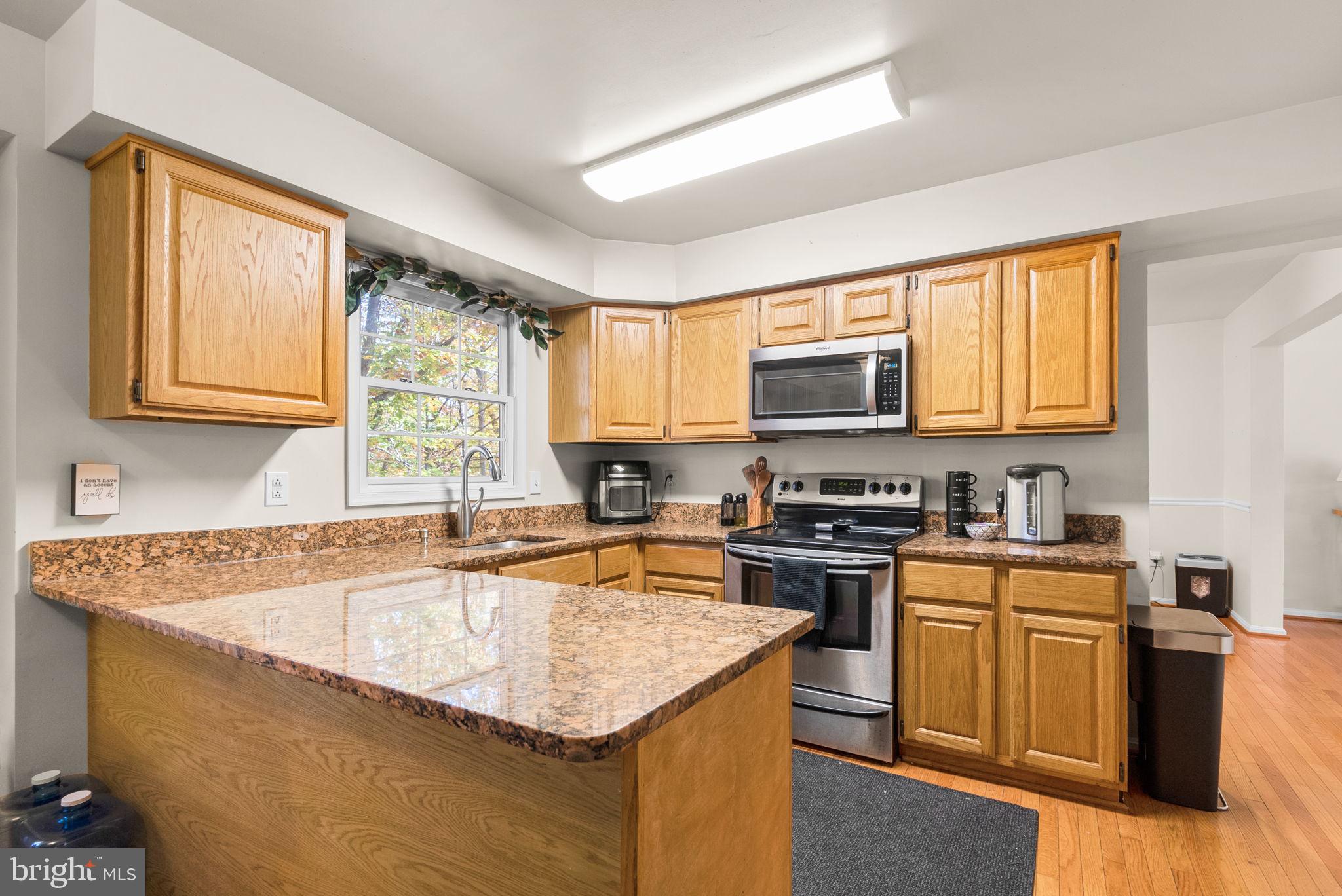 2914 Hatboro Place Upper Marlboro, MD 20772 - Photo 12 of 42 a kitchen with stainless steel appliances granite countertop a sink stove and microwave