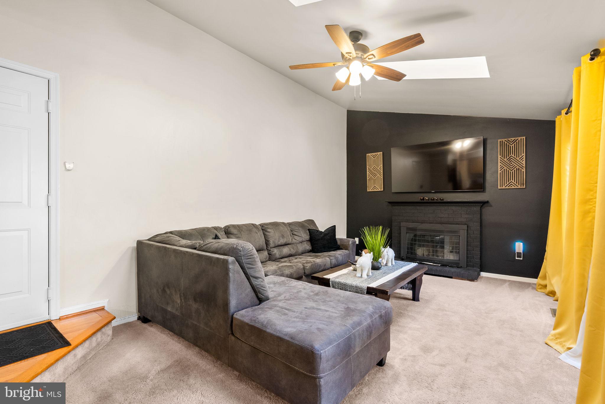 2914 Hatboro Place Upper Marlboro, MD 20772 - Photo 15 of 42 a living room with furniture a fireplace and a flat screen tv