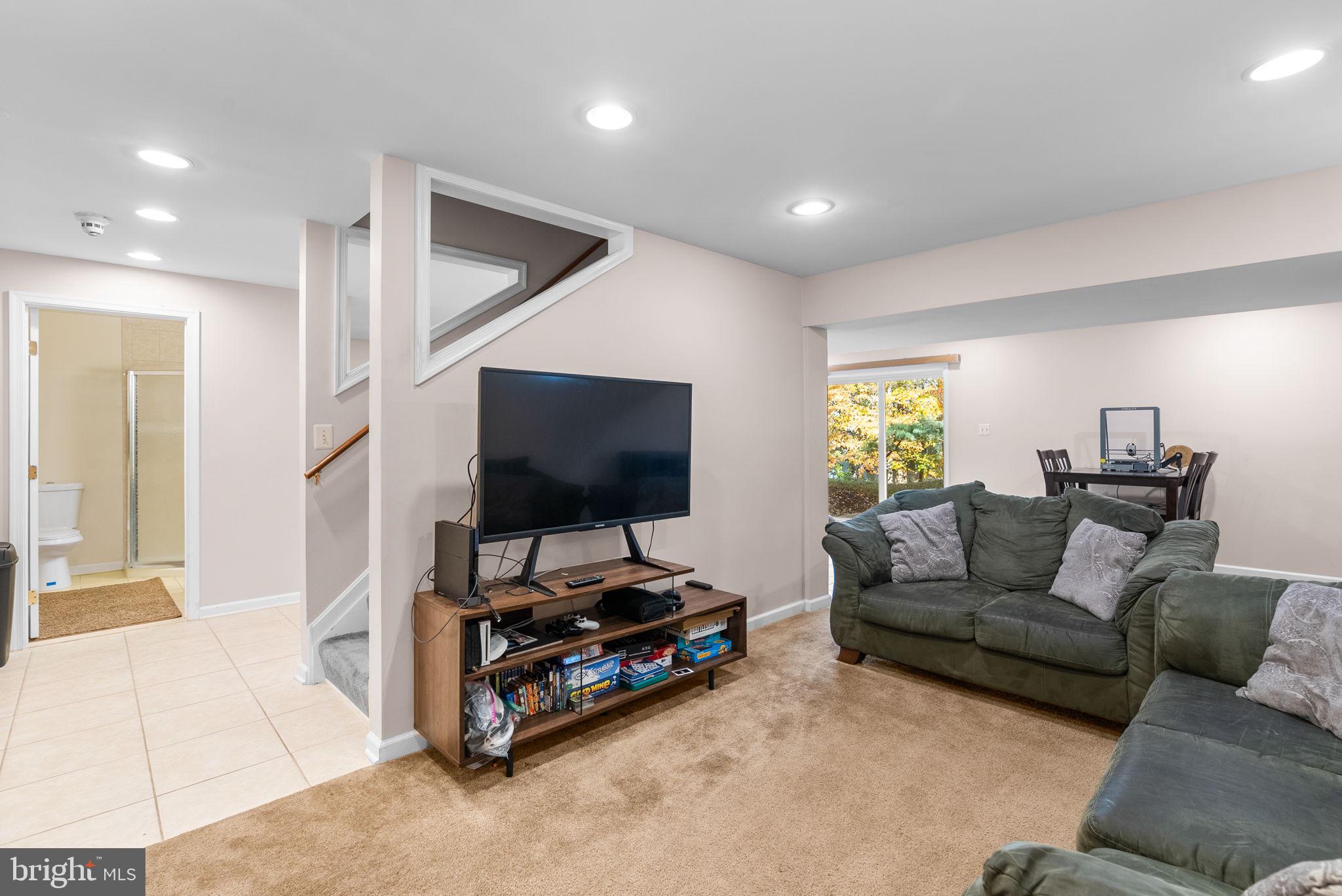 2914 Hatboro Place Upper Marlboro, MD 20772 - Photo 29 of 42 a living room with furniture and a flat screen tv