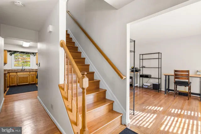 a view of entryway and hall with wooden floor