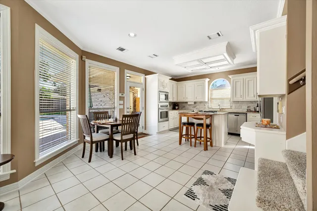 a open kitchen with stainless steel appliances kitchen island granite top and refrigerator