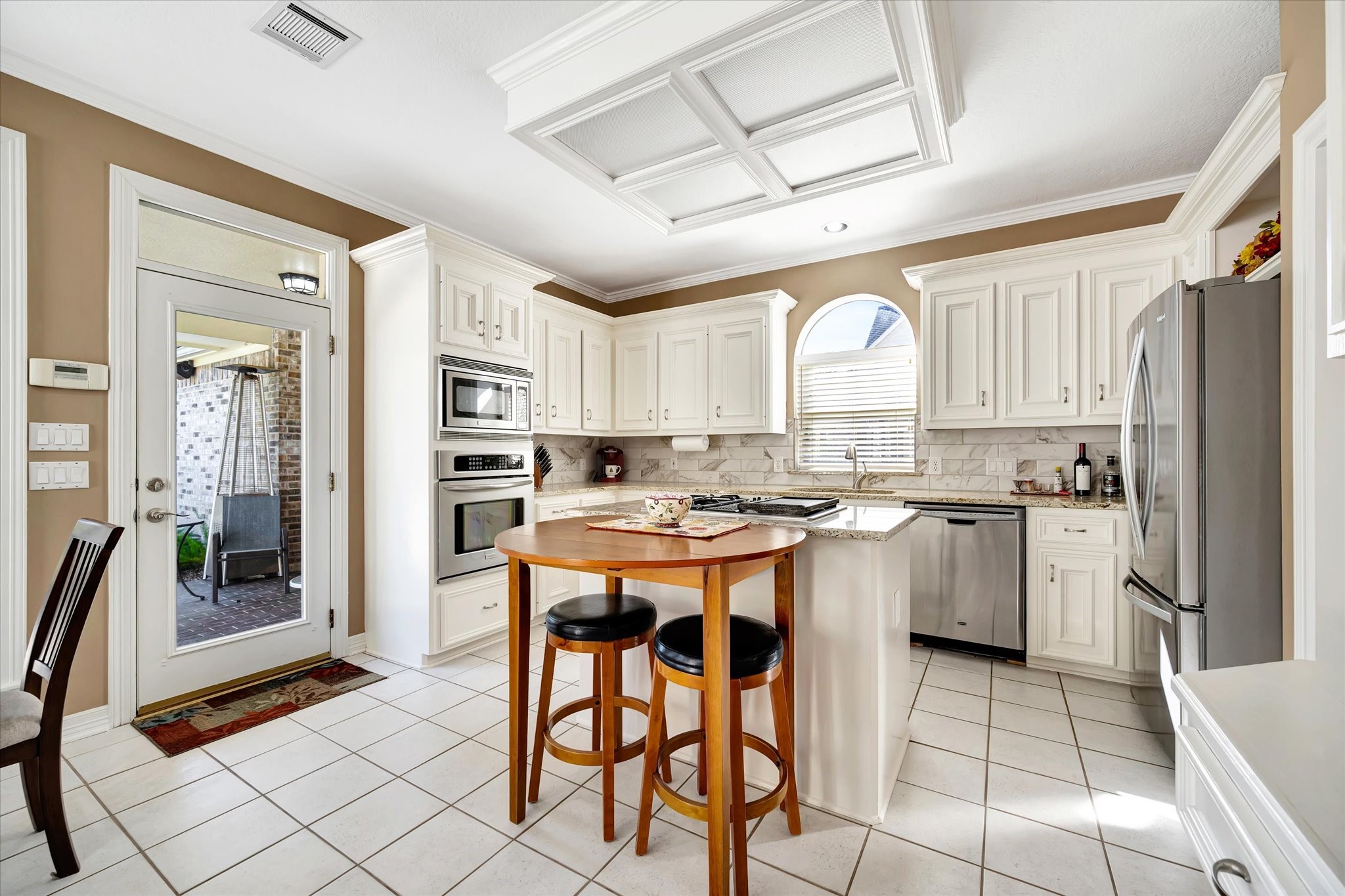 14934 Wilderness Cliff Court Houston, TX 77062 - Photo 20 of 50 a kitchen with a refrigerator a stove a sink and cabinets
