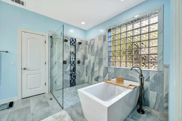 a bathroom with a sink a bathtub and shower