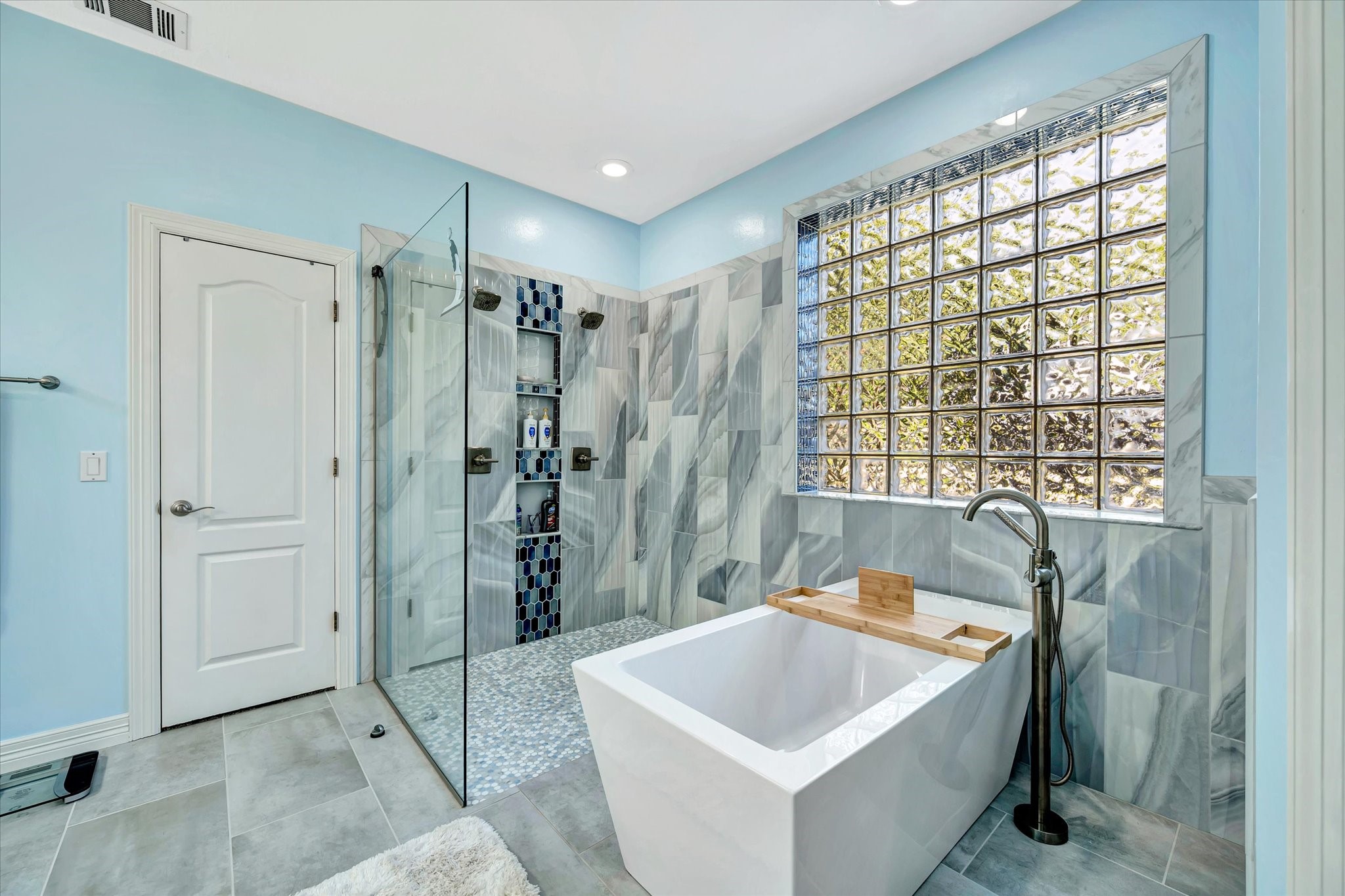 14934 Wilderness Cliff Court Houston, TX 77062 - Photo 32 of 50 a bathroom with a sink a bathtub and shower